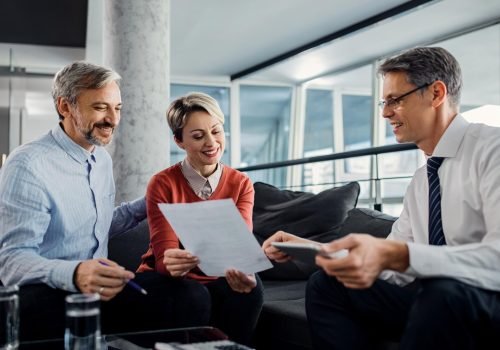 happy-couple-financial-advisor-going-through-plans-meeting_637285-11088