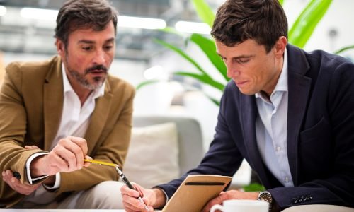 low-angle-male-coworkers-meeting-office_23-2148339373